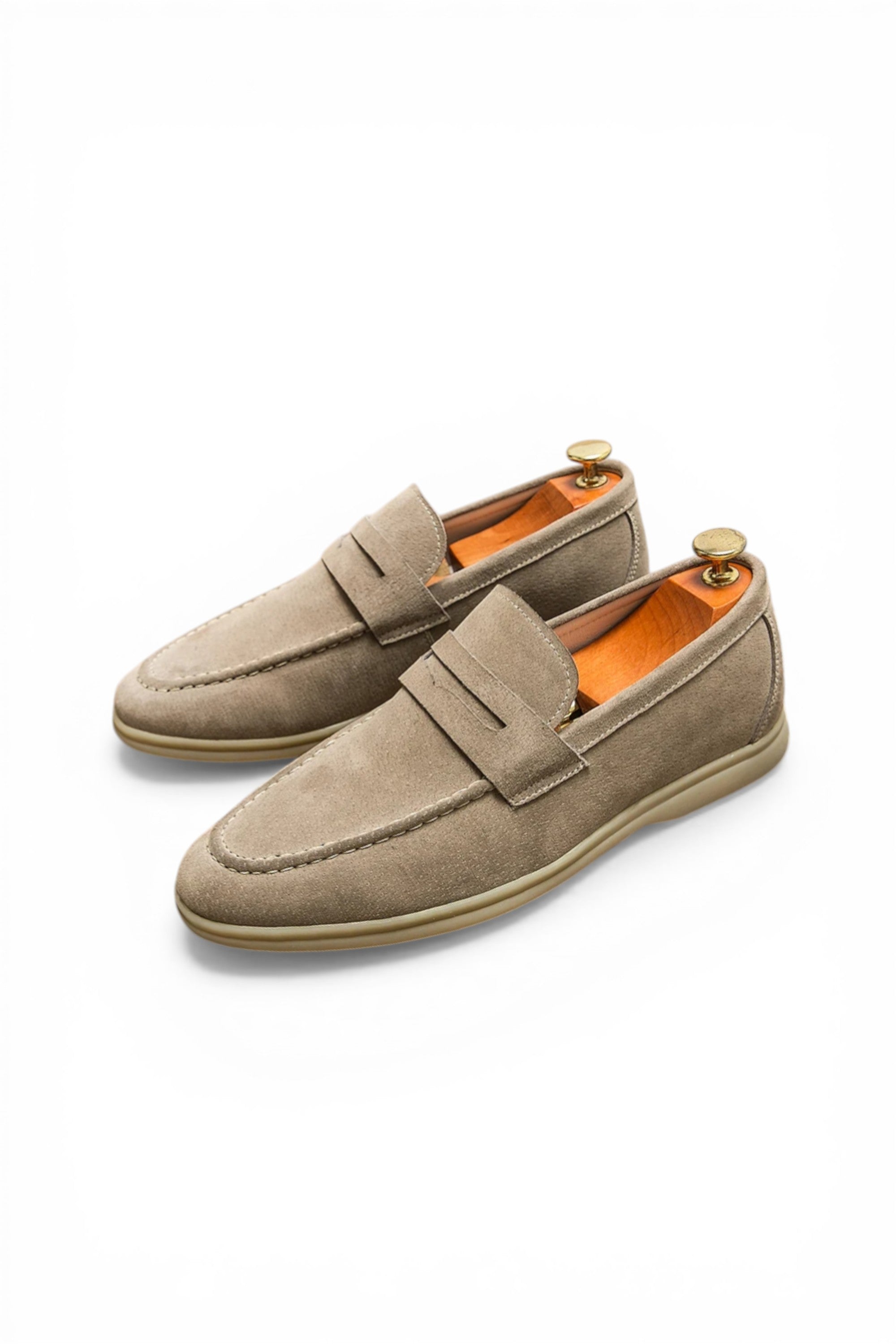 Pair of beige loafers on a white background