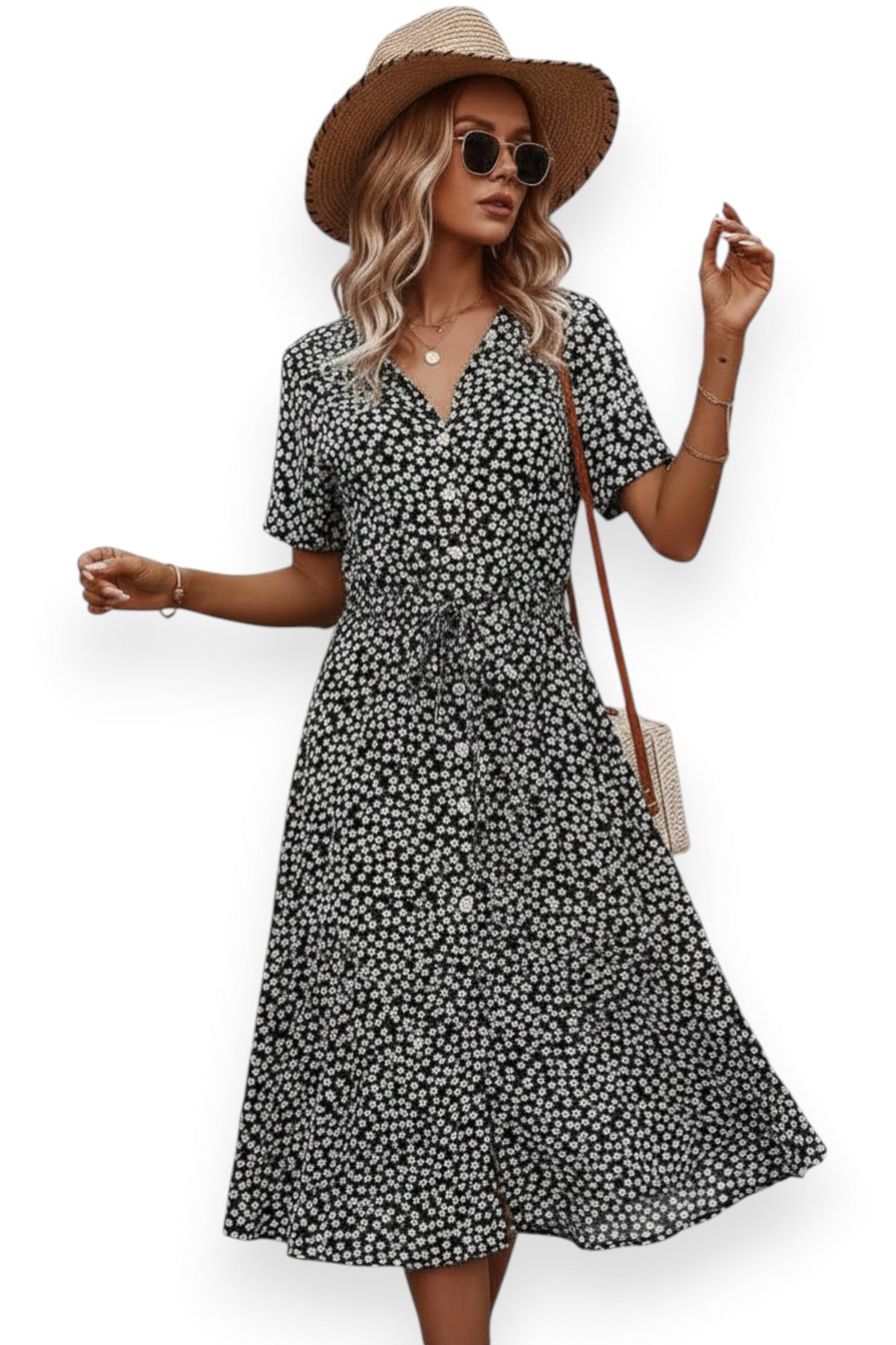 Woman wearing a black floral dress with a straw hat and sunglasses on a white background