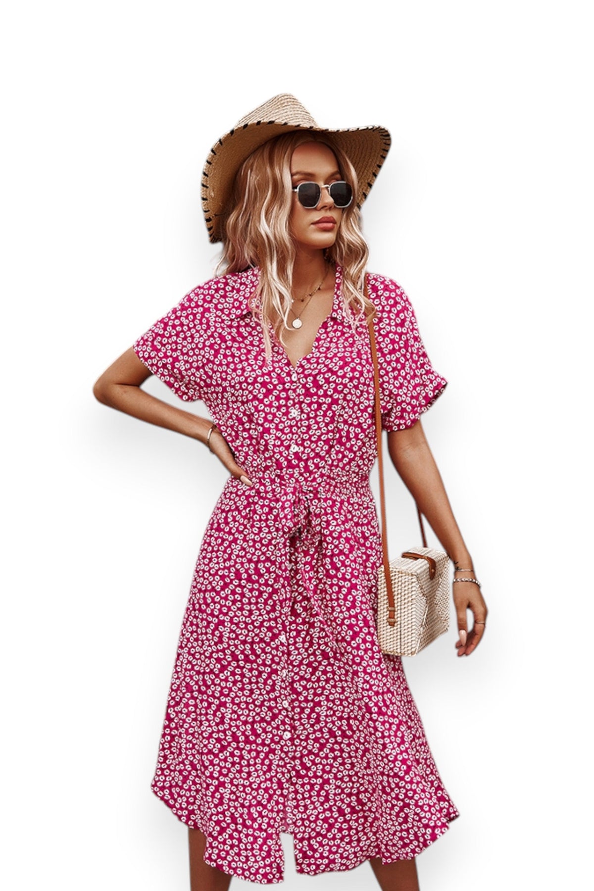Woman wearing a pink floral dress with a straw hat and sunglasses on a white background