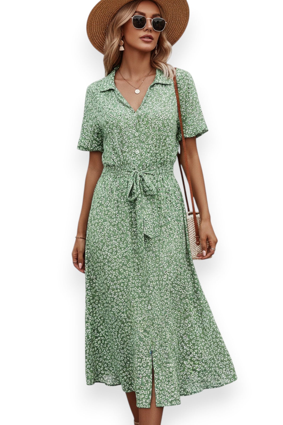 Woman wearing a green floral dress with a straw hat on a white background